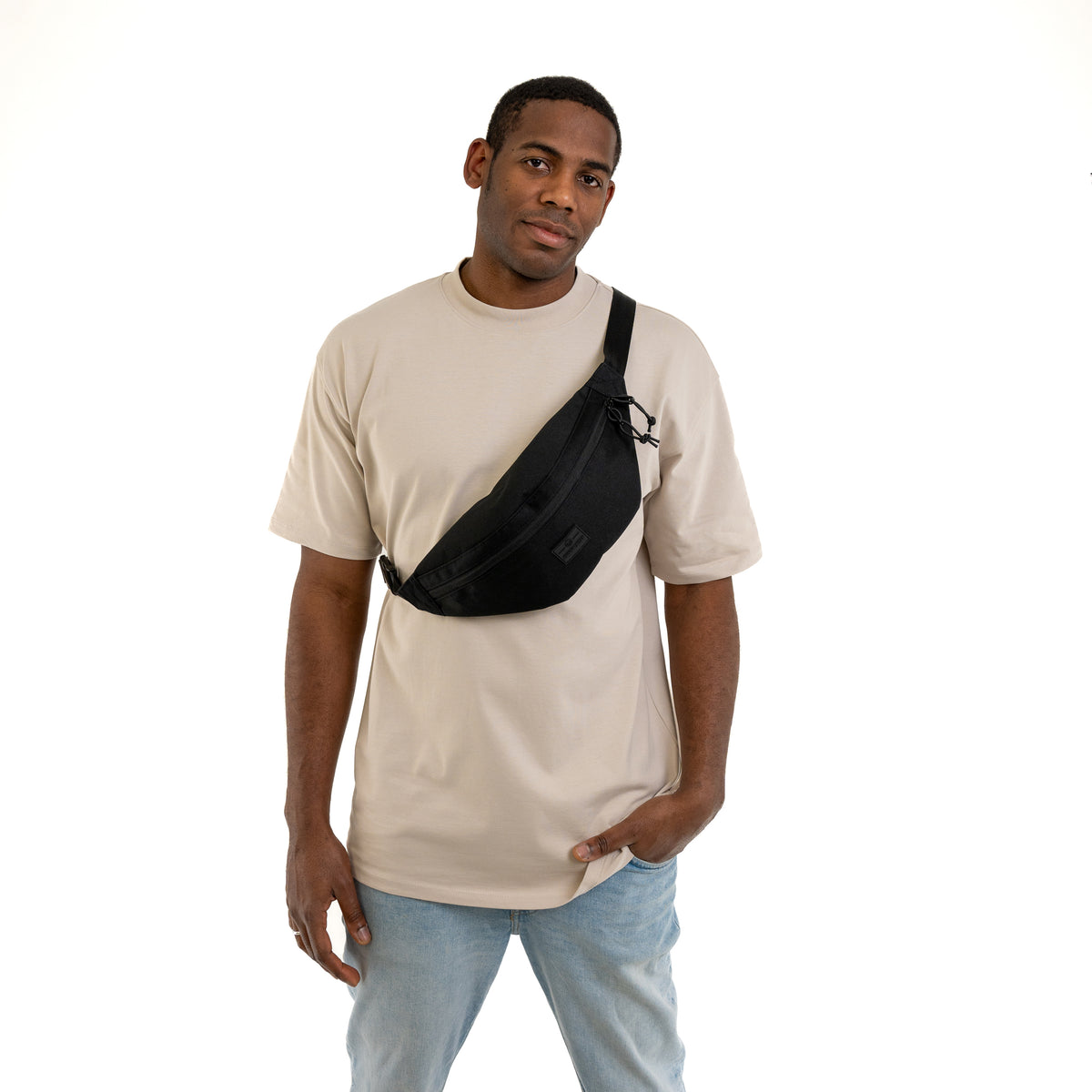 Mann trägt schwarze Bauchtasche 'Erik Large' von Johnny Urban diagonal über der Brust