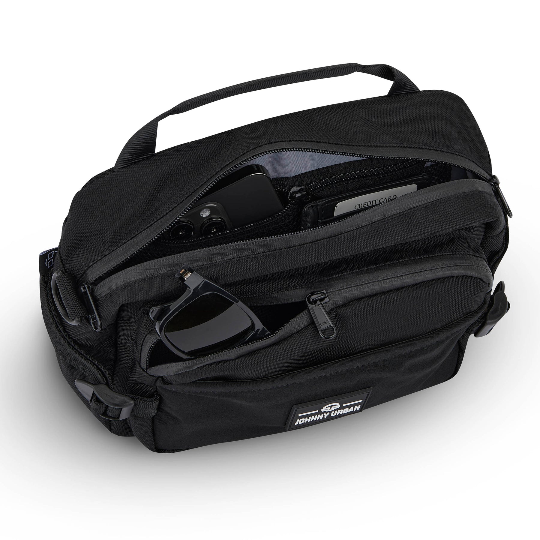 Schwarze Bauchtasche 'Travis' von Johnny Urban mit geöffneten Reißverschlusstaschen, darin Smartphone, Kreditkarte und Sonnenbrille