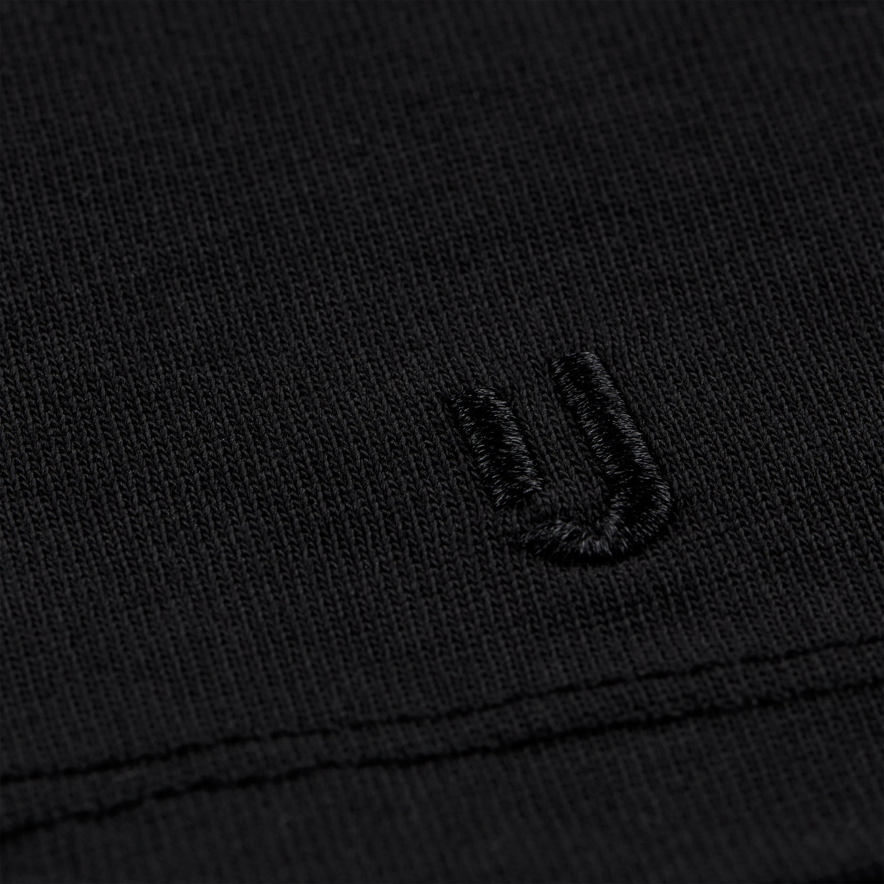 schwarzes Stoffdetail mit gesticktem 'JU'-Logo auf T-Shirt Sammy