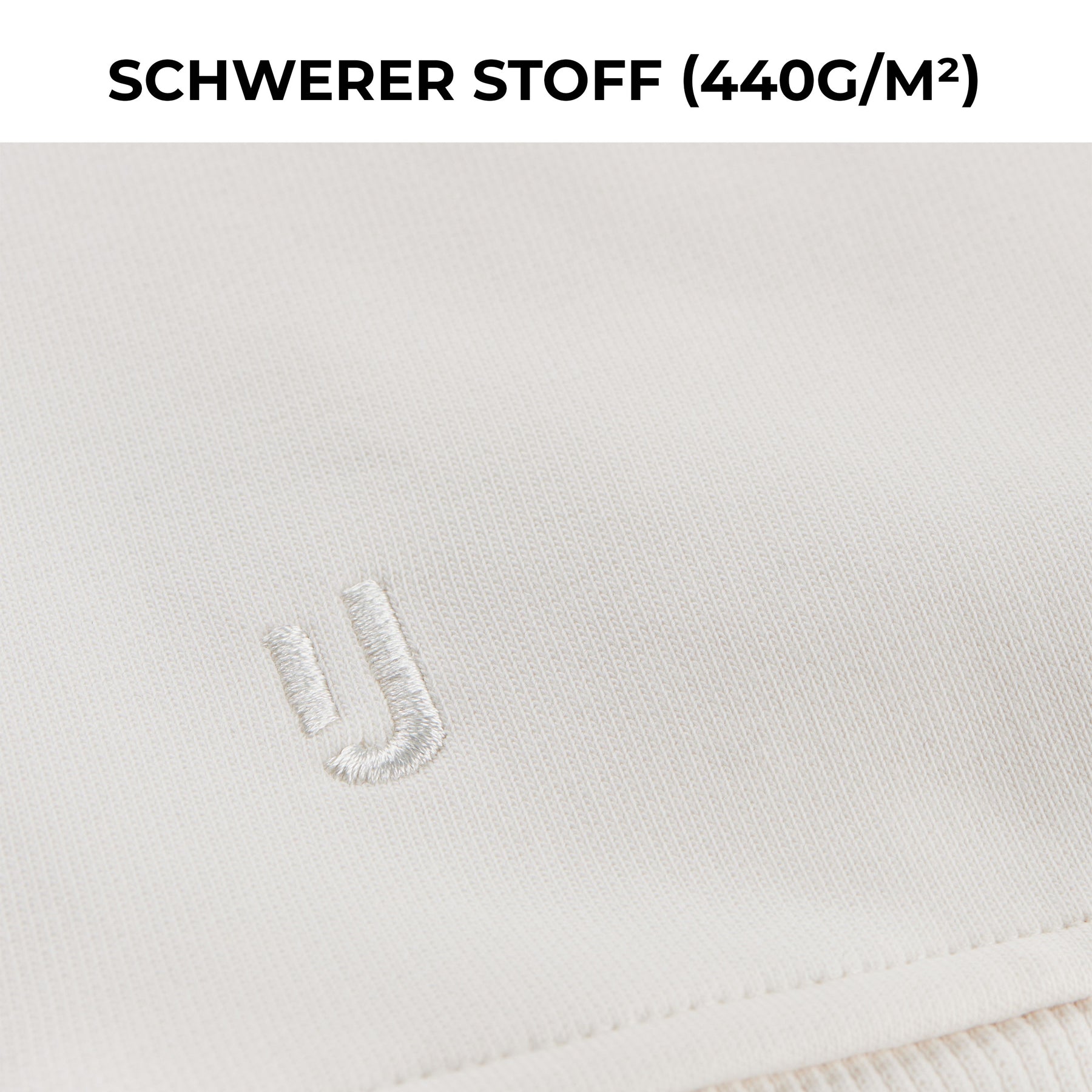 Nahaufnahme des cremefarbenen Oversized Crewnecks 'Carter' von Johnny Urban mit gesticktem Logo