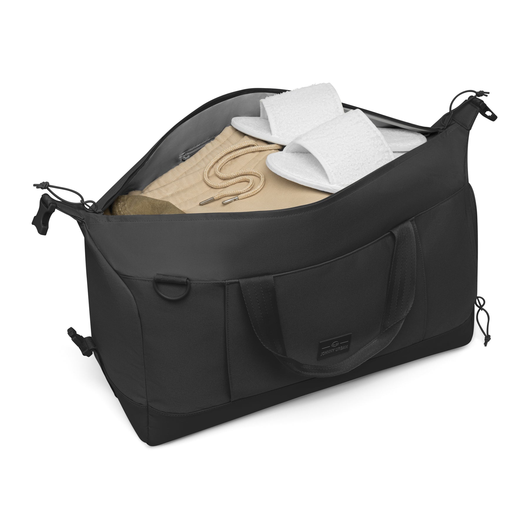 Schwarze faltbare Weekender Reisetasche 'Milan' von Johnny Urban mit beiger Kleidung und weißen Hausschuhen