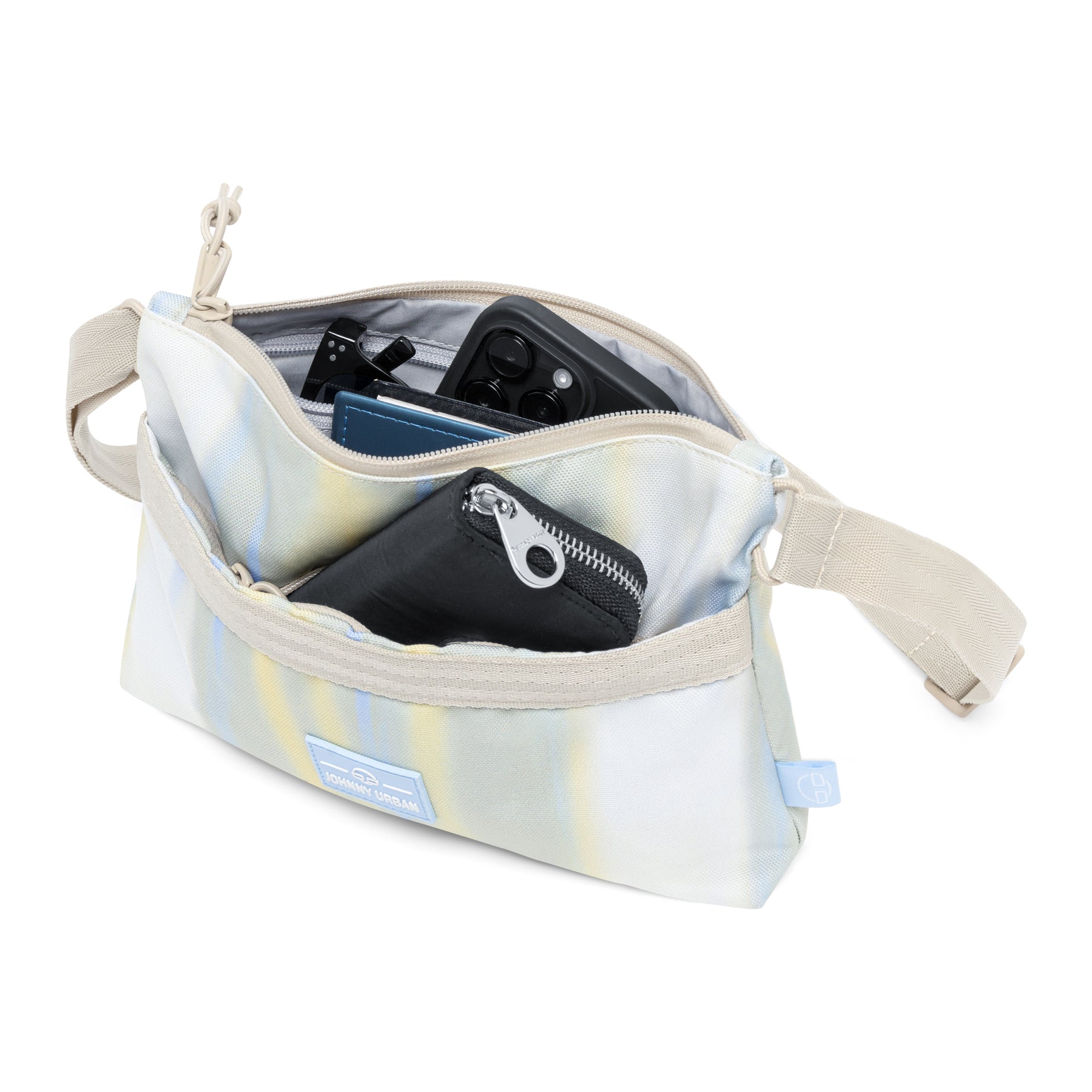 Umhängetasche 'Drew' in sandfarben mit gestreiftem Muster, geöffnet mit sichtbarem Smartphone und Geldbörse