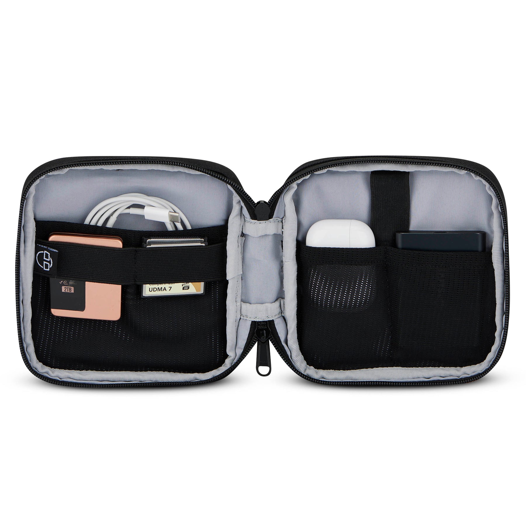 Geöffneter schwarzer Tech Organizer 'Ted' mit mehreren Taschen, gefüllt mit Kabel, Speicherkarte, AirPods und externem Akku