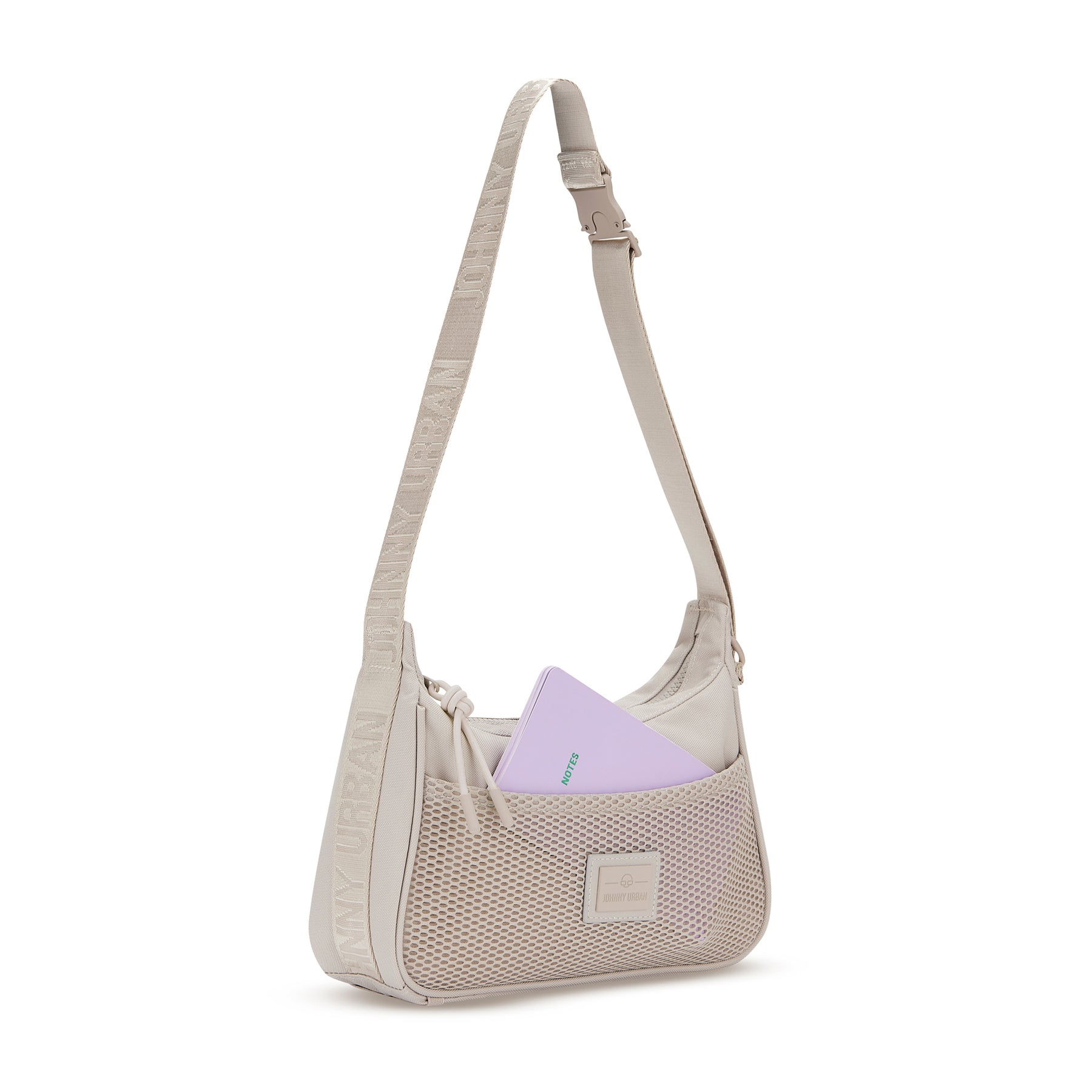 Beige Handtasche 'Maddy' mit Netzvortasche und verstellbarem Schulterriemen, lila Notizbuch steckt in der Tasche