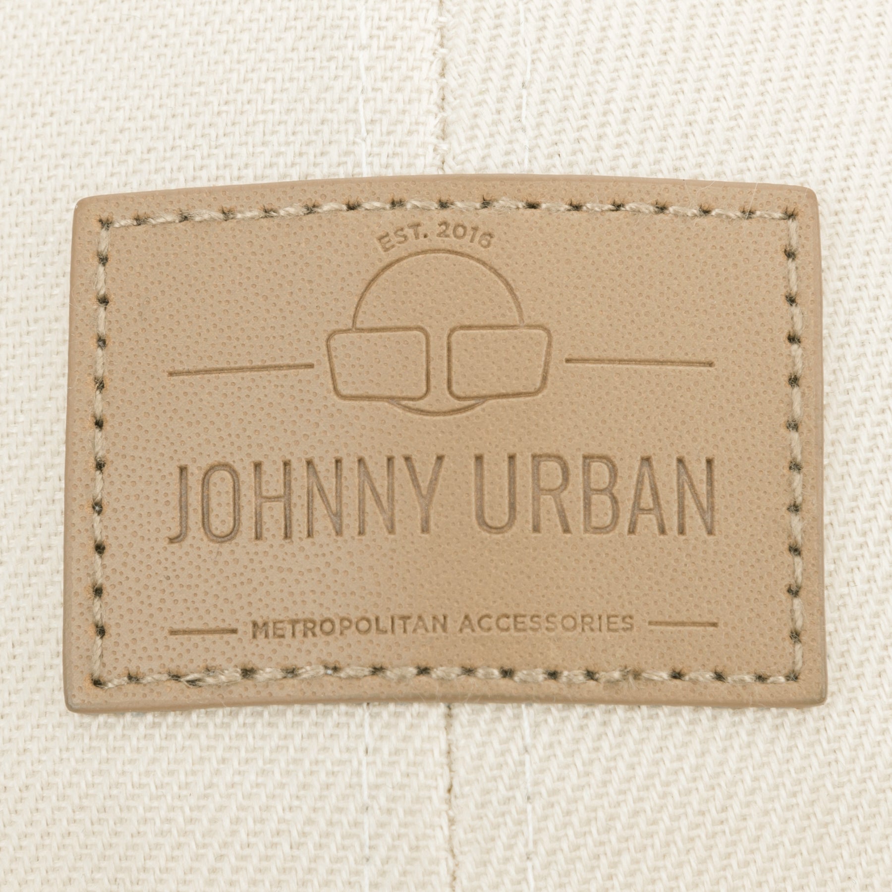 Beige Lederetikett mit ‚Johnny Urban‘ und ‚Metropolitan Accessories‘ auf beigem Canvas des Cap ‚Dean‘