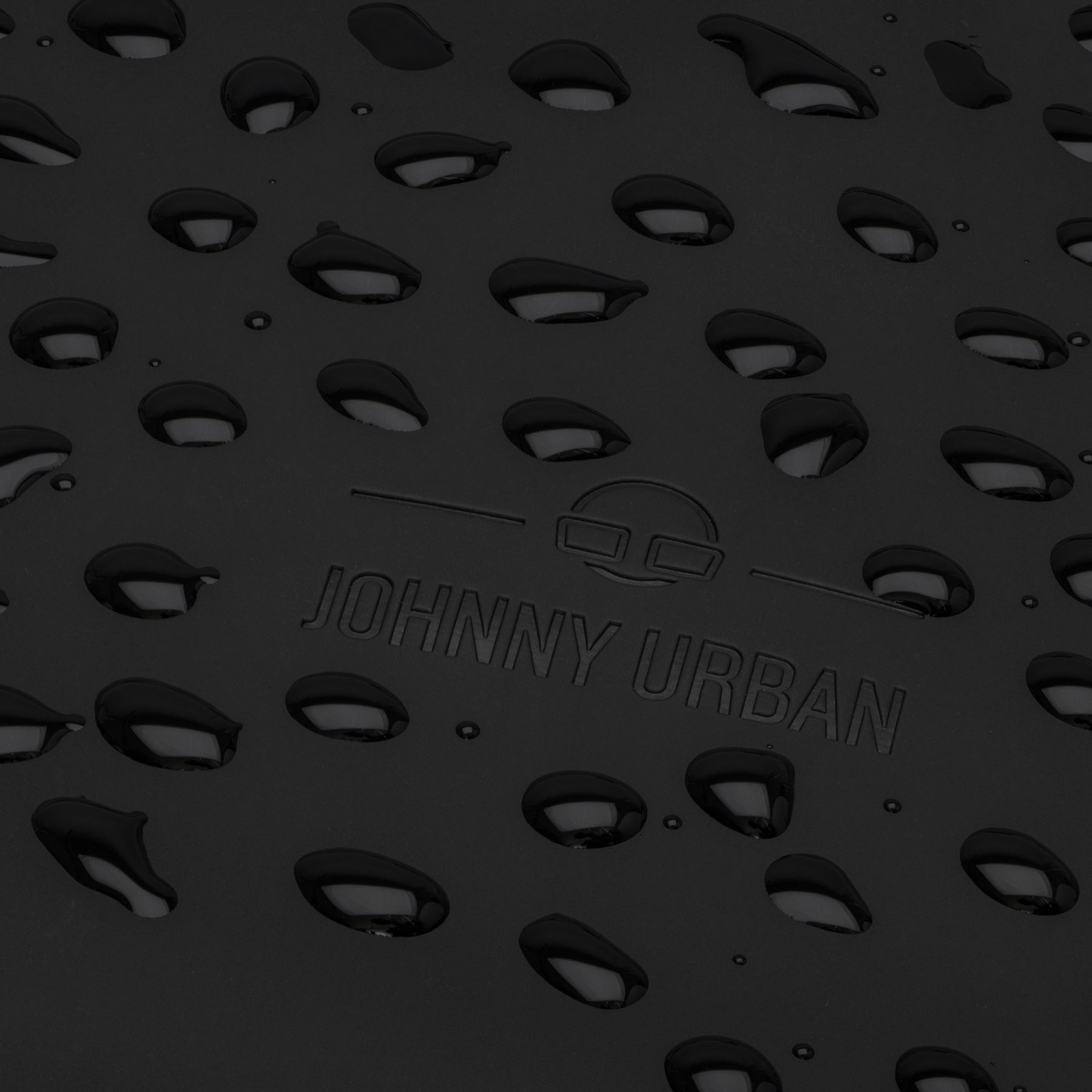 Nahaufnahme der schwarzen Oberfläche des Rolltop Rucksacks 'Harvey Medium' mit Johnny Urban Logo